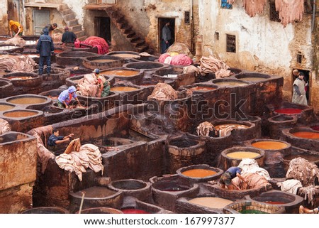 FES, MOROCCO - NOVEMBER 23: Workers at leather factory perform the work on November 23, 2013. Tanning production is one of the most ancient in Morocco
