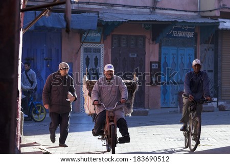 MARRAKECH, MOROCCO - FEBRUARY 28: unknown person biking on streets on February 28, 2014. With a population of over 900,000 inhabitants it is the most important city in Morocco.