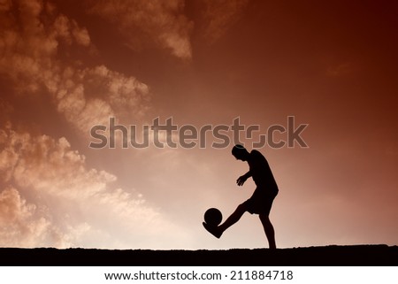 Silhouette of soccer man playing with the ball