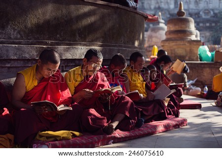 BODHGAYA, INDIA - JANUARY 21, 2015: Tibetan monks are celebrating a ceremony beneath the bodhi tree, under which the buddha became enlightened. They are chanting and readings from their books.