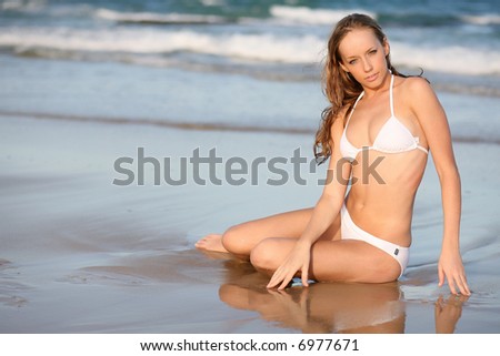 blond bikini model in white bikini on beach