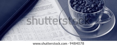 Toned business still life with financial report, cardholder and cup of coffee