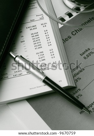 Toned business still life with coffee and financial reports