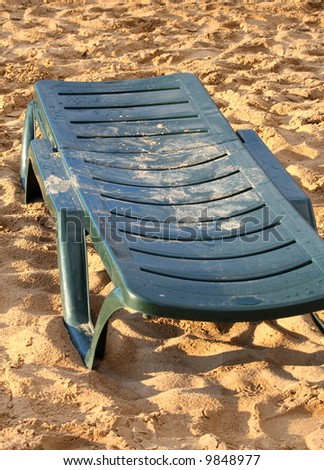 Plastic deck-chair on the sand