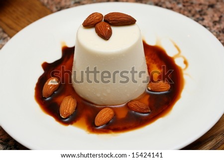 delicious creamy mousse decorated with almonds and chocolate syrup