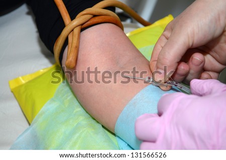 ROSTOV-ON-DON, RUSSIA - MARCH 2: Nurse injects a needle into a vein in donor - The City Blood Service makes a promo action for donorship popularization, March 2, 2013 in Rostov-on-Don, Russia