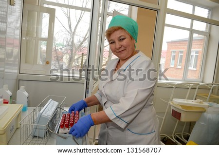 ROSTOV-ON-DON, RUSSIA - MARCH 2: Nurse with digestion tubes for blood donations - The City Blood Service makes a promo action for donorship popularization, March 2, 2013 in Rostov-on-Don, Russia