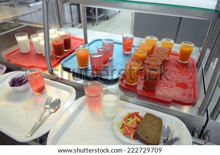 Factory canteens - yogurt, juice, juice, salad, bread on trays