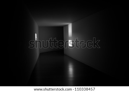 A window providing light in the side of a black tunnel  It represent that there is light in the side and not just in the end of the tunnel.