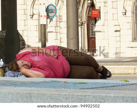 PHILADELPHIA, PENNSYLVANIA, USA - SEPTEMBER 5: Unidentified woman sleeps on sidewalk on September 5, 2011 in Philadelphia. A recent survey found more than 500 homeless people living in Philadelphia.