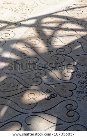 LOS ANGELES, CA - MAY 19: Shadows of the Watts Towers cast on designs in the cement below in Los Angeles on May 19, 2012. Simon Rodia designed and built the entire Watts Towers sculpture by himself.
