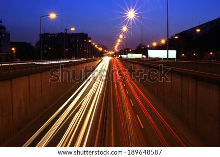 Night traffic in the city, car lights traces in motion