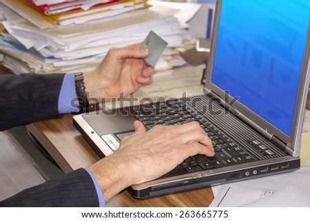 Business man shopping online, using laptop and credit card