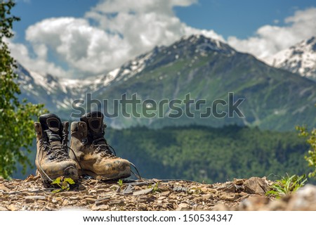 tourist boots and mountain on summer time
