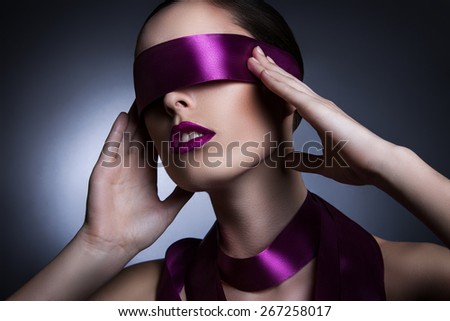 portrait of a girl with a purple ribbon in her eyes