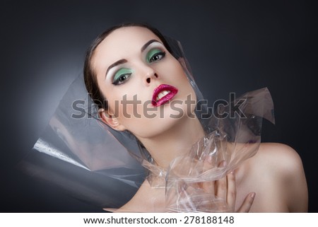 portrait of a beautiful young girl. Girl with a transparent film
