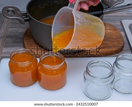 Similar – Image, Stock Photo Homemade jam being poured in a jar