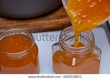 Image, Stock Photo Homemade jam being poured in a jar