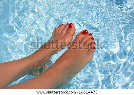 Relaxing woman with his foot on the water