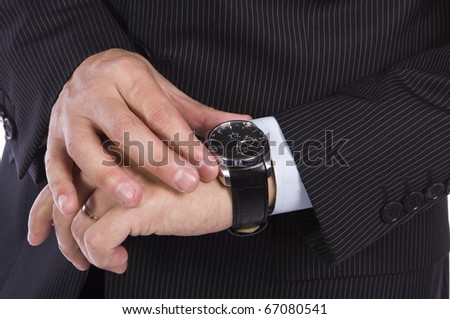 Businessman checking the time on his watch