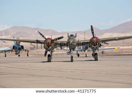 NELLIS AFB, LAS VEGAS, NV - NOVEMBER 14: Vintage Lockheed P-38 Lightning WWII-era fighter aircraft taxiing after performing at Aviation Nation 2009 on November 14, 2009 in Nellis AFB, Las Vegas, NV.