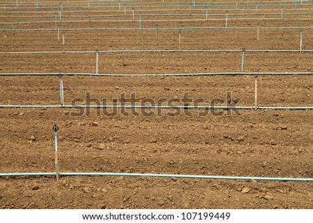 Plow land and irrigation system ready for agricultural