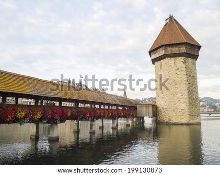 LUCERN, SWITZERLAND -OCTOBER 24: Chapel Bridge with Reuss River on October 24, 2011 in Luzern, Switzerland. The bridge was restored in 2002 after the terrible fire which broke out in 1993.