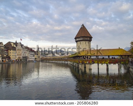 LUZERN, SWITZERLAND -OCTOBER 24, 2011: Chapel Bridge with Reuss River on October 24, 2011 in Lucern, Switzerland. The bridge was restored in 2002 after a terrible fire which broke out in 1993.