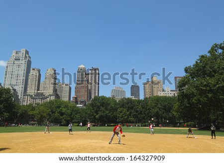 NEW YORK CITY - JULY 18:Softball teams playing at Heckscher Ballfields in Central Park on July 18, 2013.There are 26 softball and baseball fields open to the public in Central Park