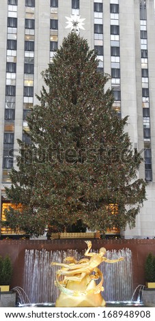 NEW YORK - DECEMBER 19: Rockefeller Center Christmas Tree and statue of Prometheus at the Lower Plaza of Rockefeller Center in Midtown Manhattan on December 19, 2013.