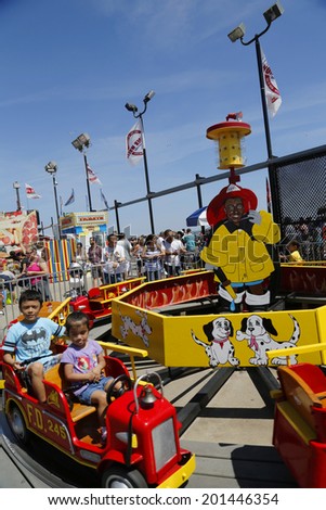 BROOKLYN, NY- JUNE 15: Kids ride at Coney Island Luna Park on June 15, 2014. Coney Island Luna Park was destroyed by fire in 1944, then reopened in 2010