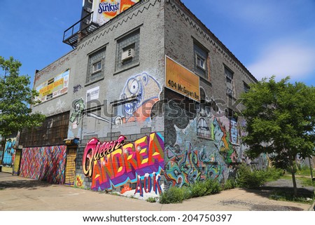 NEW YORK - JUNE 21: Building covered with murals and graffiti in Williamsburg section in Brooklyn on June 21, 2014. Williamsburg is an influential hub of current indie rock and hipster culture