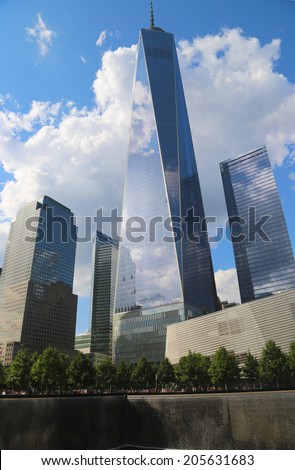 NEW YORK - JULY 17, 2014: Freedom Tower, September 11 Museum and Reflection Pool with Waterfall in September 11 Memorial Park on July 17, 2014