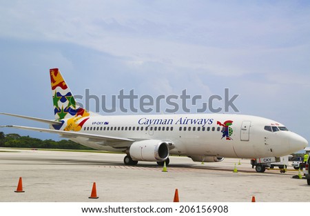 GRAND CAYMAN, CAYMAN ISLANDS - June 10: Cayman Airways Boeing 737 at Owen Roberts International Airport at Grand Cayman on June 10, 2014. It is the flag carrier airline of the Cayman Islands