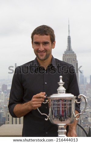 NEW YORK CITY - SEPTEMBER 9: US Open 2014 champion Marin Cilic posing with US Open trophy on the Top of the Rock Observation Deck at Rockefeller Center on September 9, 2014 in New York