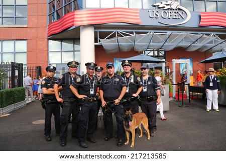 NEW YORK - SEPTEMBER 7: NYPD transit bureau K-9 police officers and K-9 dog providing security at National Tennis Center during US Open 2014 on September 7, 2014 in New York