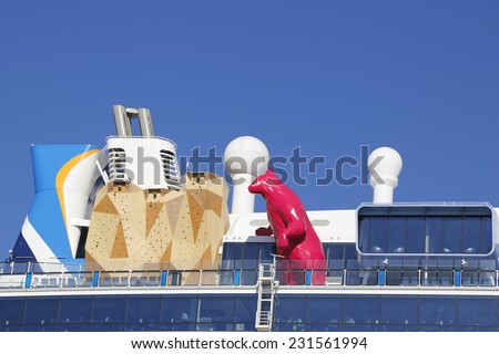 BAYONNE, NEW JERSEY - NOVEMBER 18: Royal Caribbean Cruise Ship Quantum of the Seas with Lawrence Argent\'s statue of the Magenta Polar Bear and Rock Climbing Wall on an upper deck on November 18, 2014