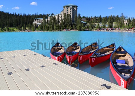LAKE LOUISE, CANADA - JULY 27:Canoes on beautiful turquoise Lake Louise on July 27, 2014. Lake Louise is the second most-visited destination in the Banff National Park.