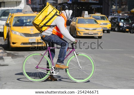 NEW YORK - FEBRUARY 19, 2015: Unidentified delivery man on bike in Manhattan