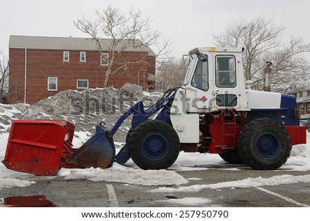 BROOKLYN, NEW YORK - MARCH 3, 2015: Tractor Snow Plow in Brooklyn, NY during record breaking winter