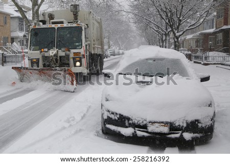 BROOKLYN, NEW YORK - MARCH 5, 2015: New York Department of Sanitation truck cleaning streets in Brooklyn, NY during massive Winter Storm Thor