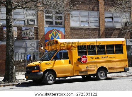 NEW YORK - APRIL 14, 2015:  School bus in front of public school in Manhattan
