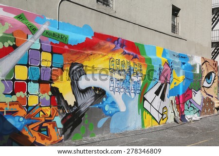 NEW YORK - MAY 14, 2015: Mural art in Little Italy in Manhattan. A mural is any piece of artwork painted or applied directly on a wall, ceiling or other large permanent surface