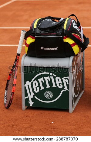 PARIS, FRANCE- MAY 29, 2015: Babolat Aero Pro racquet and tennis bag at Le Stade Roland Garros in Paris. Babolat is an Official Partner of the tournament and provides racquets, balls, strings