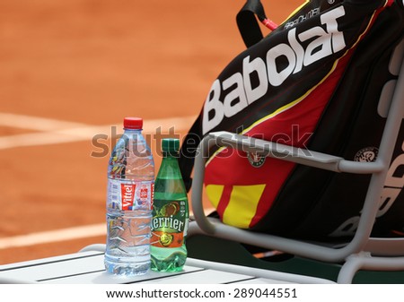 PARIS, FRANCE- MAY 29, 2015: Perrier and Vittel bottled water and Babolat tennis bag at Le Stade Roland Garros in Paris.