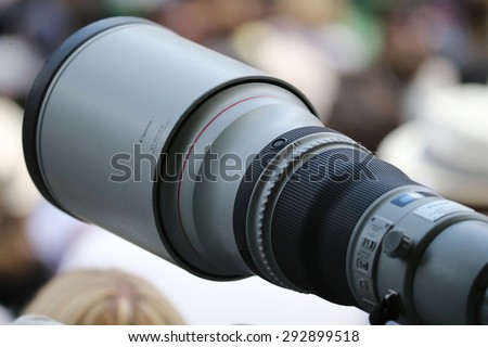 PARIS, FRANCE- MAY 30, 2015: A photojournalist uses a Canon telephoto lens to capture action at Roland Garros 2015 in Paris, France