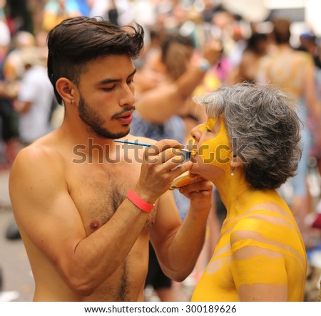 NEW YORK - JULY 18, 2015: Artists paint 100 fully nude models of all shapes and sizes during second NYC Body Painting Day in midtown Manhattan featuring artist Andy Golub in New York