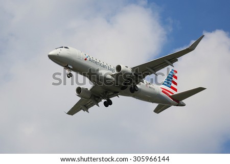NEW YORK - AUGUST 13, 2015: American Eagle Embraer ERJ-145 jet descending for landing at JFK International Airport in New York