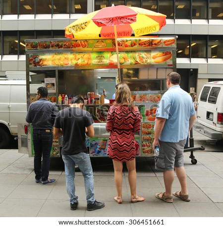NEW YORK - JULY 9, 2015: Customers placing order at street food vendor in Midtown Manhattan. There are about 4,000 mobile food vendors licensed by the city