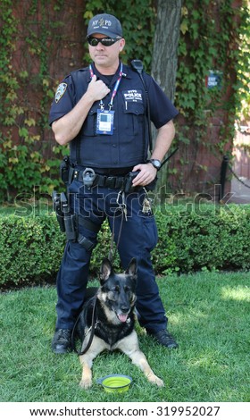NEW YORK - SEPTEMBER 9, 2015: NYPD transit bureau K-9 police officer and German Shepherd K-9 providing security at National Tennis Center during US Open 2015 in New York